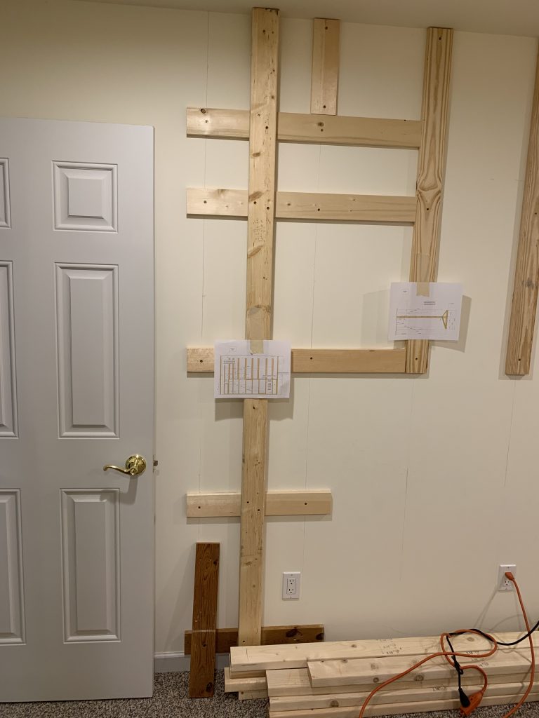 1x4's (flat side) are secured to wall to provide solid surfaces to screw in the backer board.